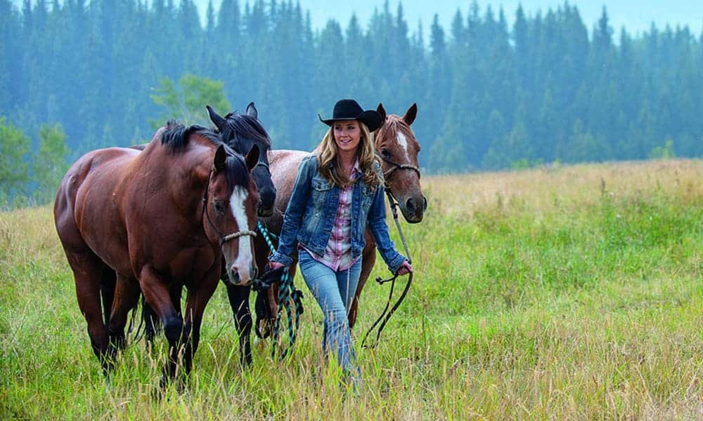 Amber Marshall with her horses on her ranch. 