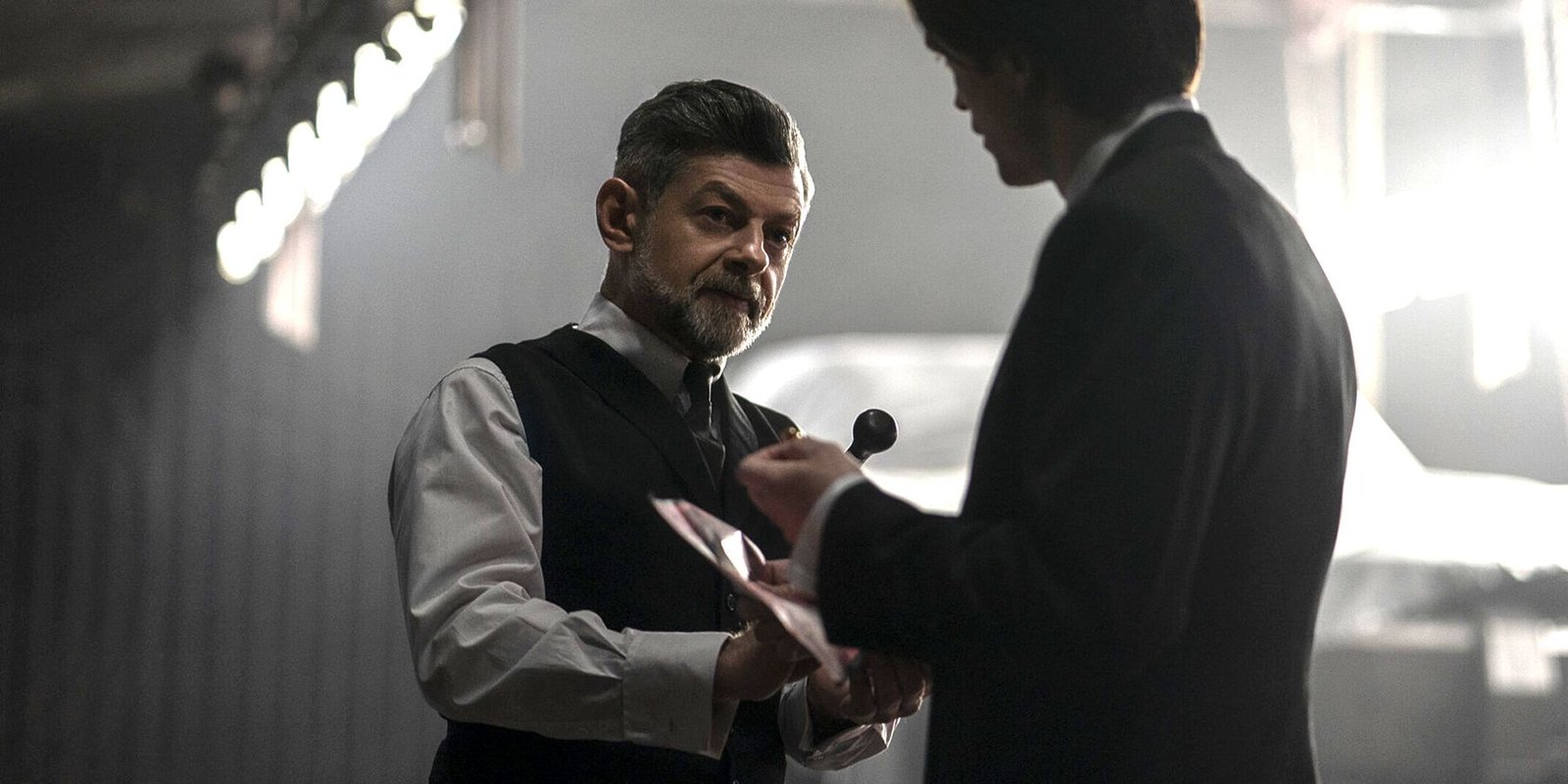 Andy Serkis as Alfred Pennyworth and Robert Pattinson as Bruce Wayne in The Batman (2022)